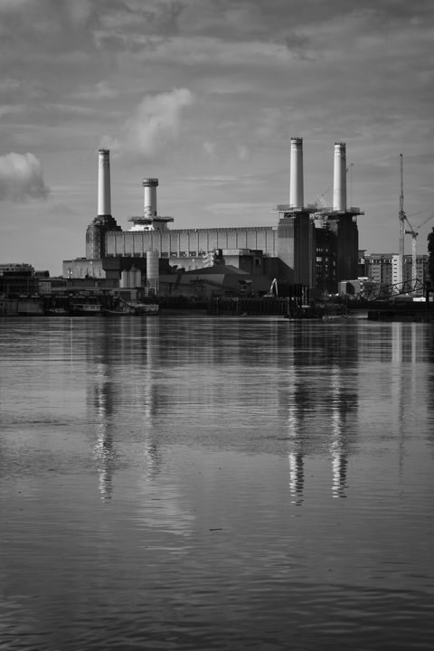 Battersea Power Station in black and white under patterned sky